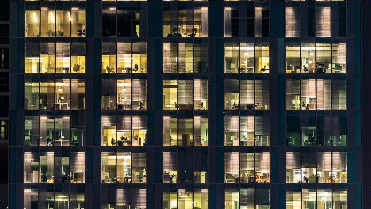 Architecture - Blinking light in window of the multi-storey building of glass and steel lighting and people within timelapse close up view. Dubai, UAE