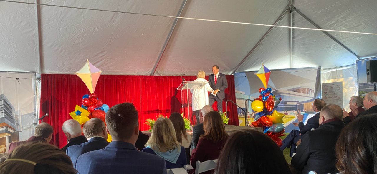 Dr. Joseph Harroz Jr., president of OU, shakes hands with Dr. Robyn Cowperthwaite, child and adolescent psychiatrist, as he approches the podium to speak at the children's behavioral health center groundbreaking ceremony.