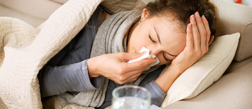 Sick Woman. Flu. Woman Caught Cold. Sneezing into Tissue