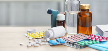 Different medicines and pills on wooden table