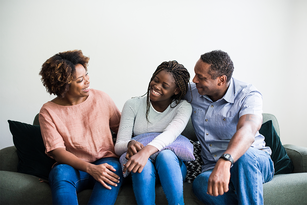 A family of three shares a happy moment.