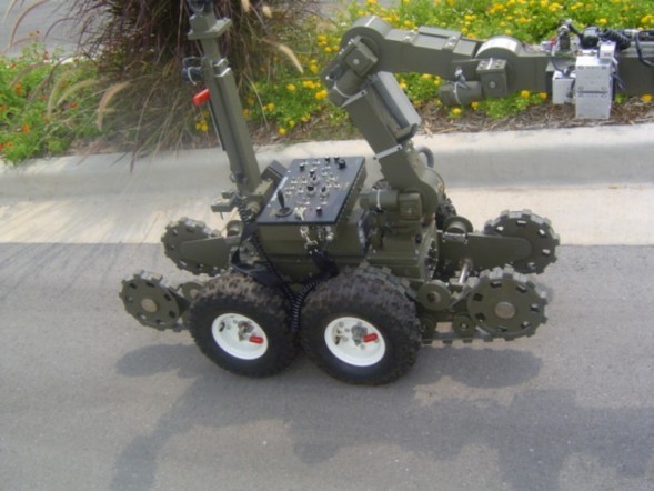 Bomb Squad Robot sitting still next to a curb.