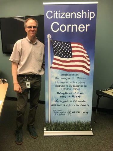 Mr. Struby standing in front of banner