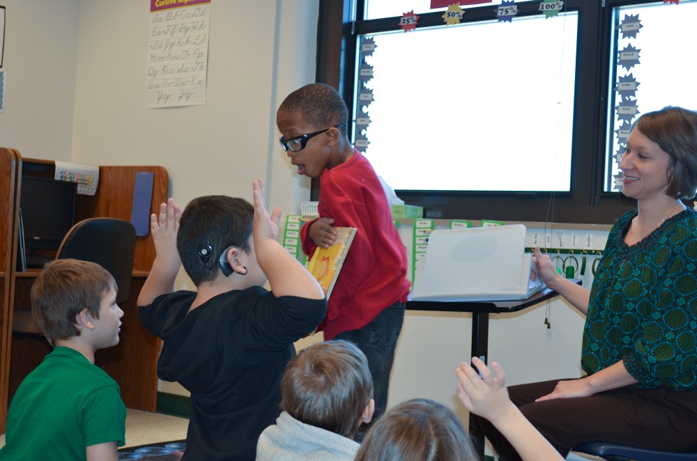 A deaf student reads to the class