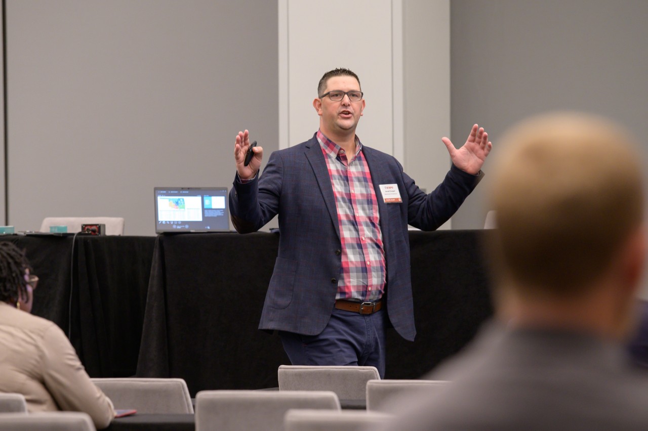 Jared Cooper speaks animatedly during the Commerce breakout session.