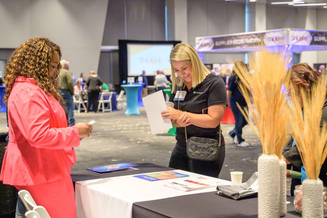 Cabinet staff engages with attendee at the Agriculture booth.