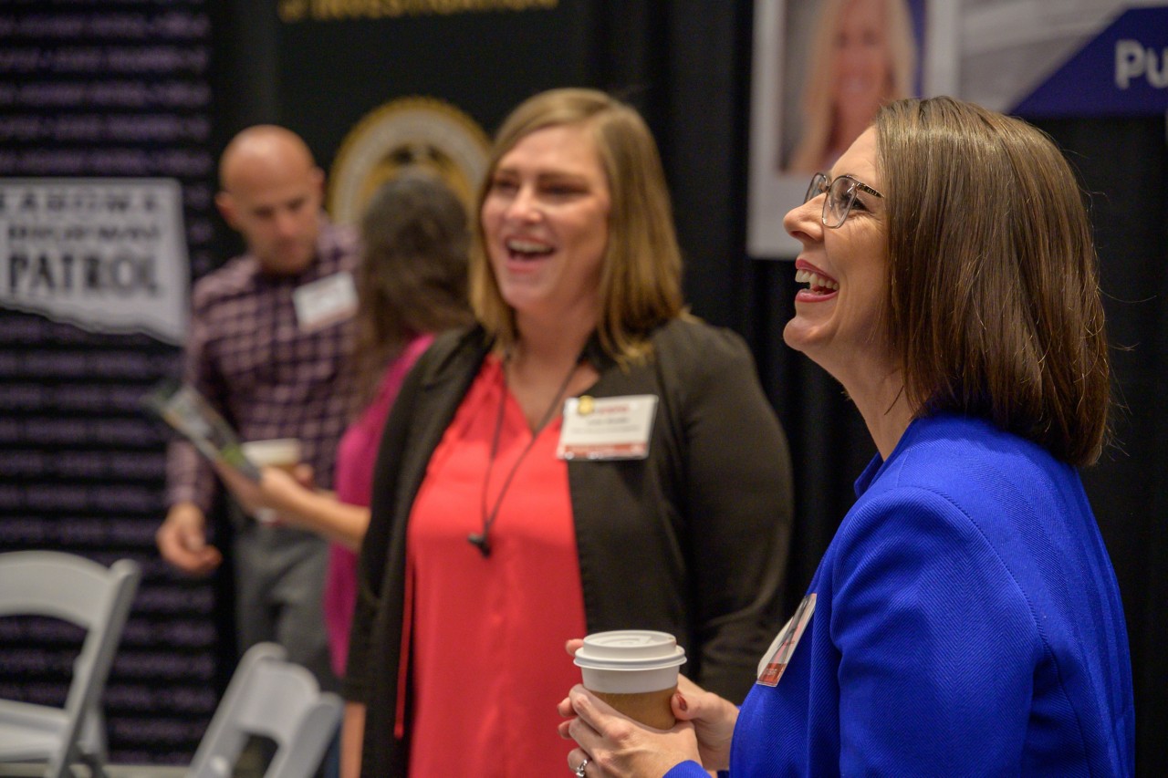 Cabinet staff laugh at the Public Safety booth.