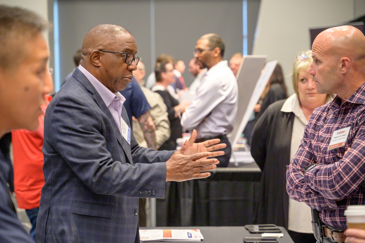 Attendee talking to the Public Safety cabinet booth.