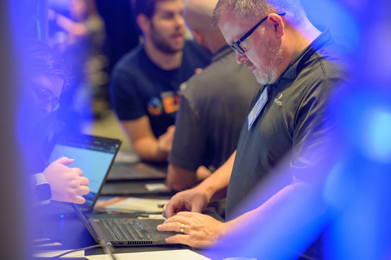 Attendee using a laptop to sign up as a state bidder at the Supplier Regsitration booth.