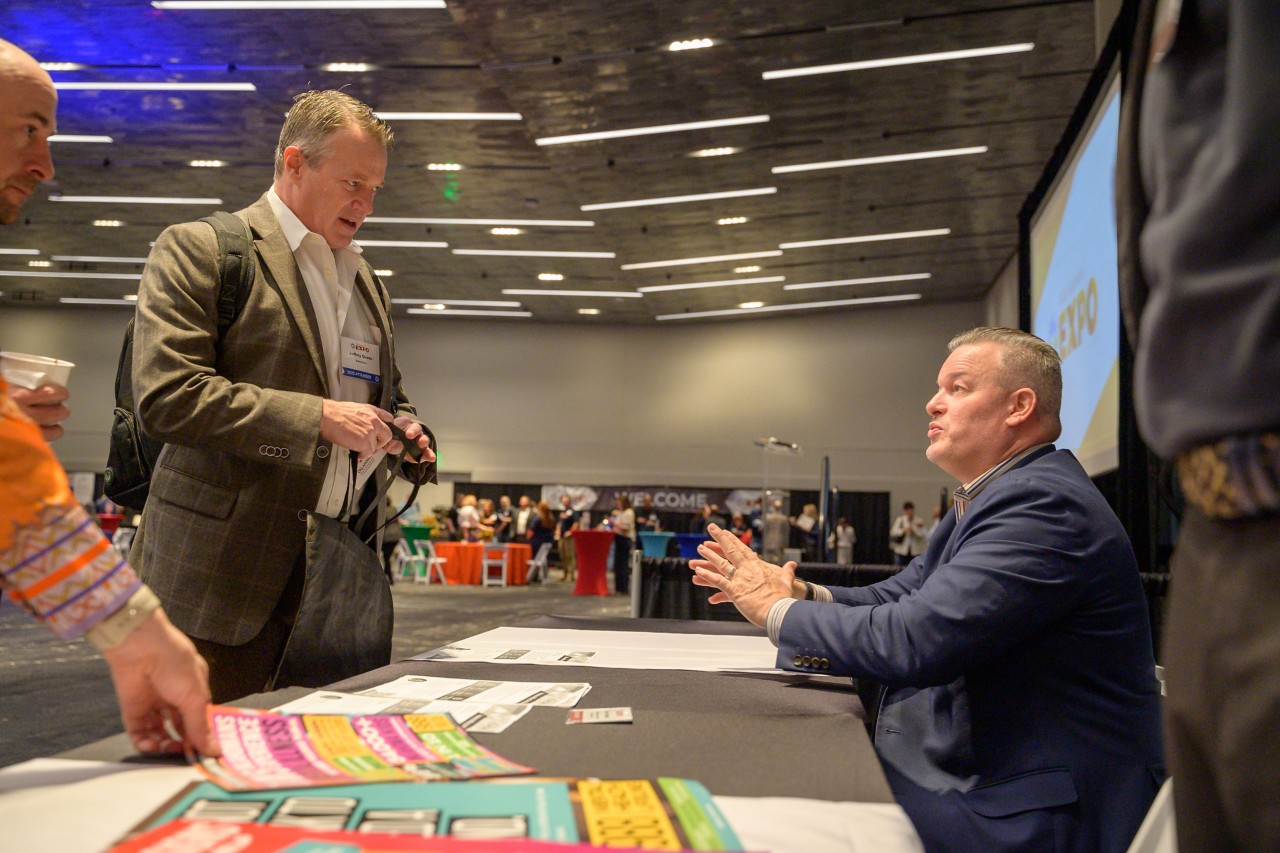 Rob Teel talking to attending businesses at the Veterans Affairs and Military cabinet booth.